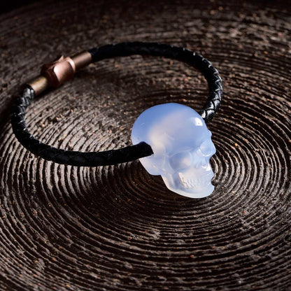 1.0" Blue Chalcedony Crystal Skull Necklace - Side View on Natural Wood