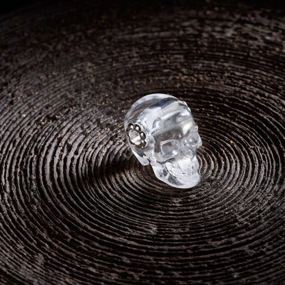 1.0" Clear Quartz Crystal Skull Necklace - Side View on Natural Wood