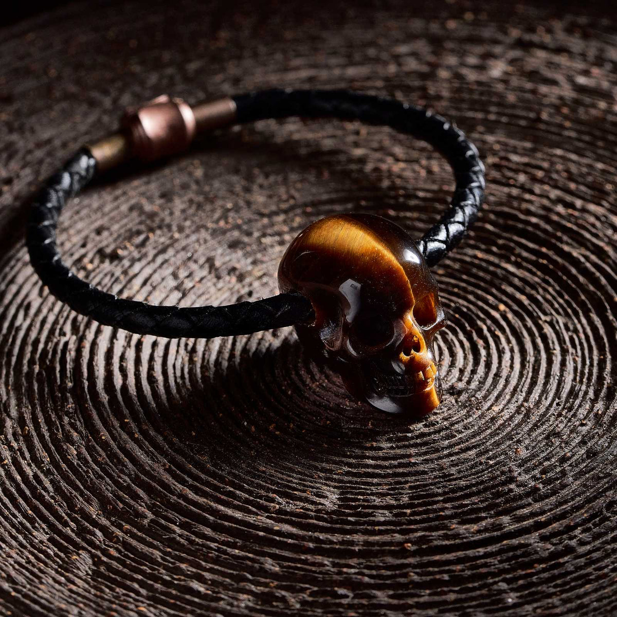 1.0" Tiger's Eye Crystal Skull Necklace - Side View on Natural Wood