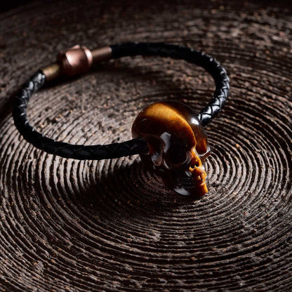 1.0" Tiger's Eye Crystal Skull Necklace - Side View on Natural Wood
