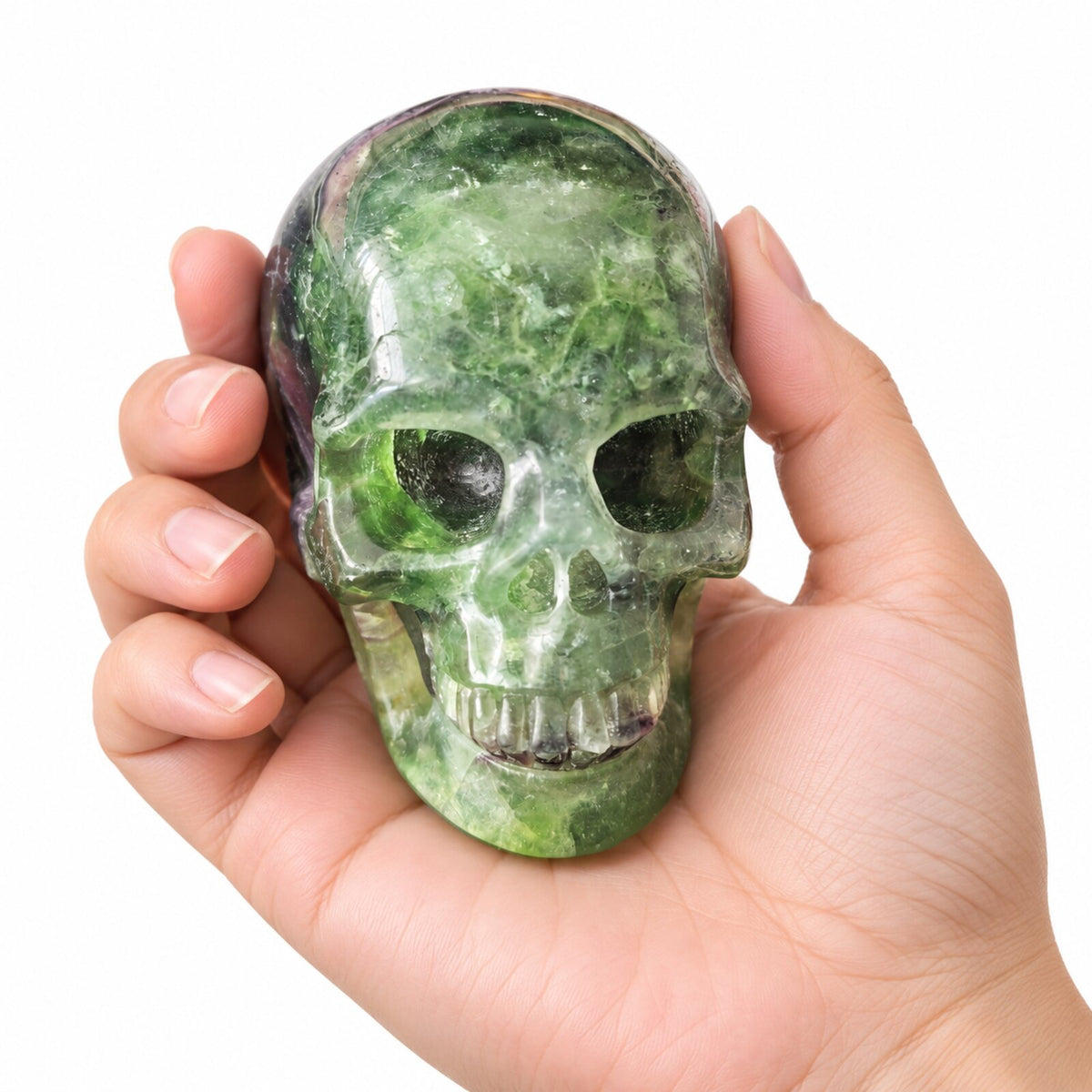 3 inch green fluorite crystal skull held in hand for scale